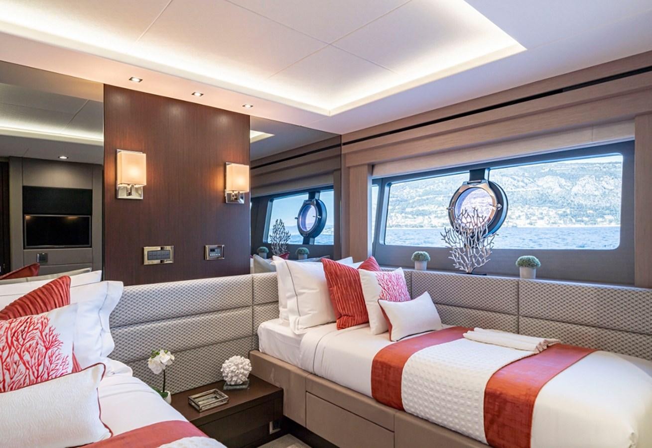 a room with a bed and a window aboard HERO Yacht for Sale
