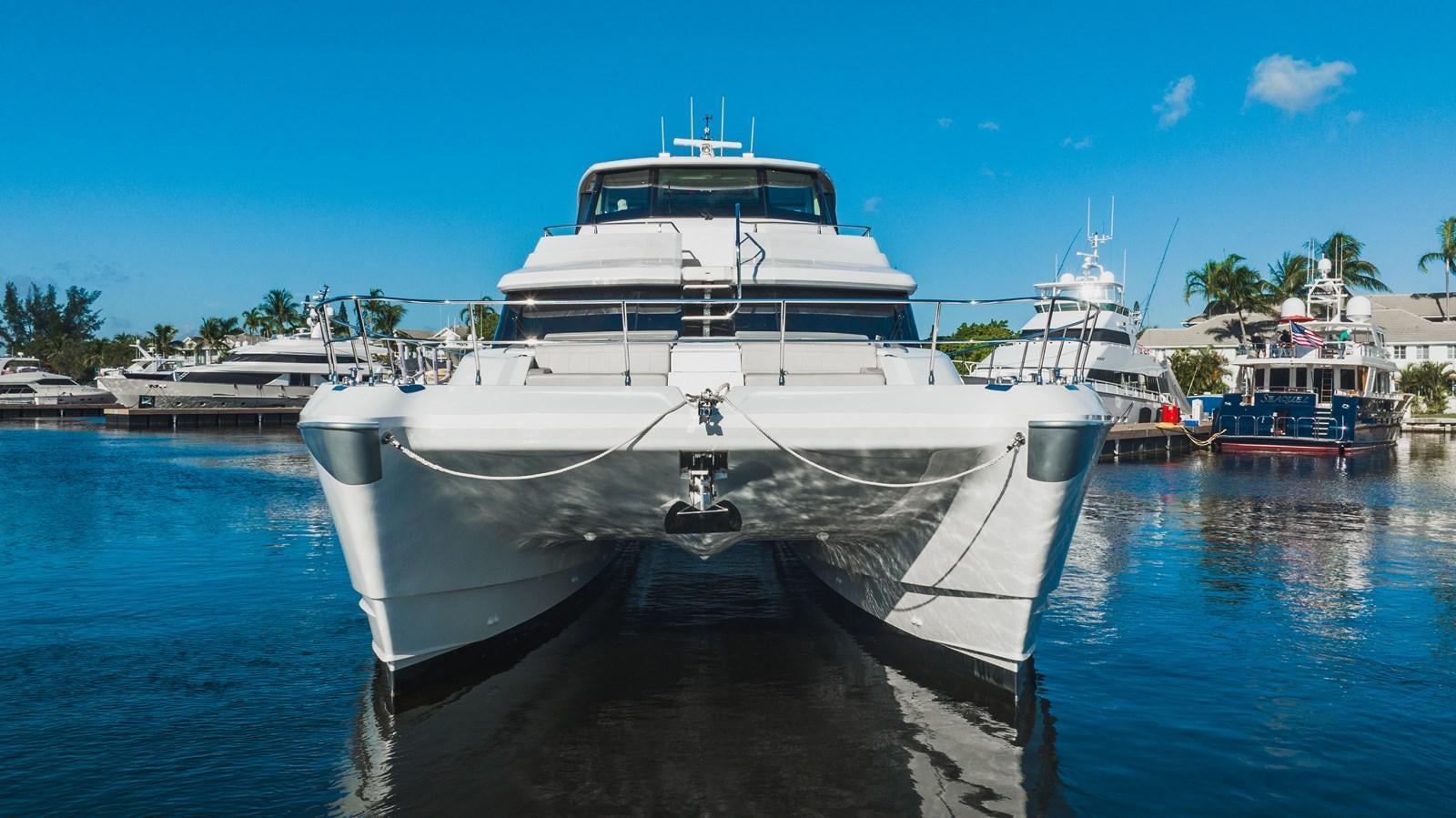 a large white boat in a harbor aboard PLANE TO SEA Yacht for Sale