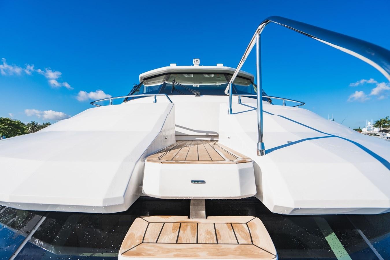 a white boat on a dock aboard PLANE TO SEA Yacht for Sale