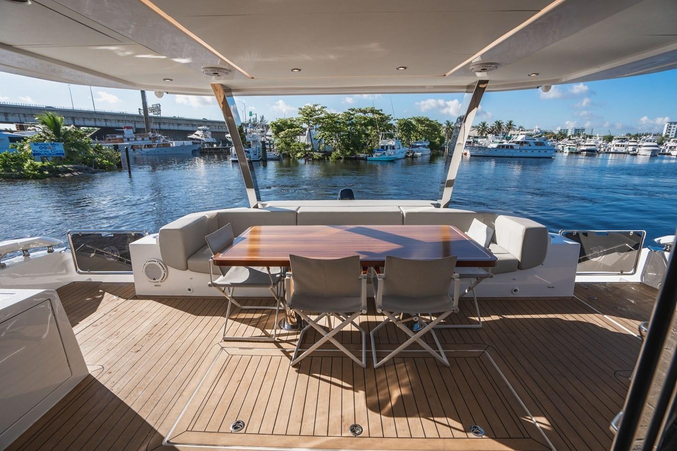 a table and chairs on a deck aboard PLANE TO SEA Yacht for Sale