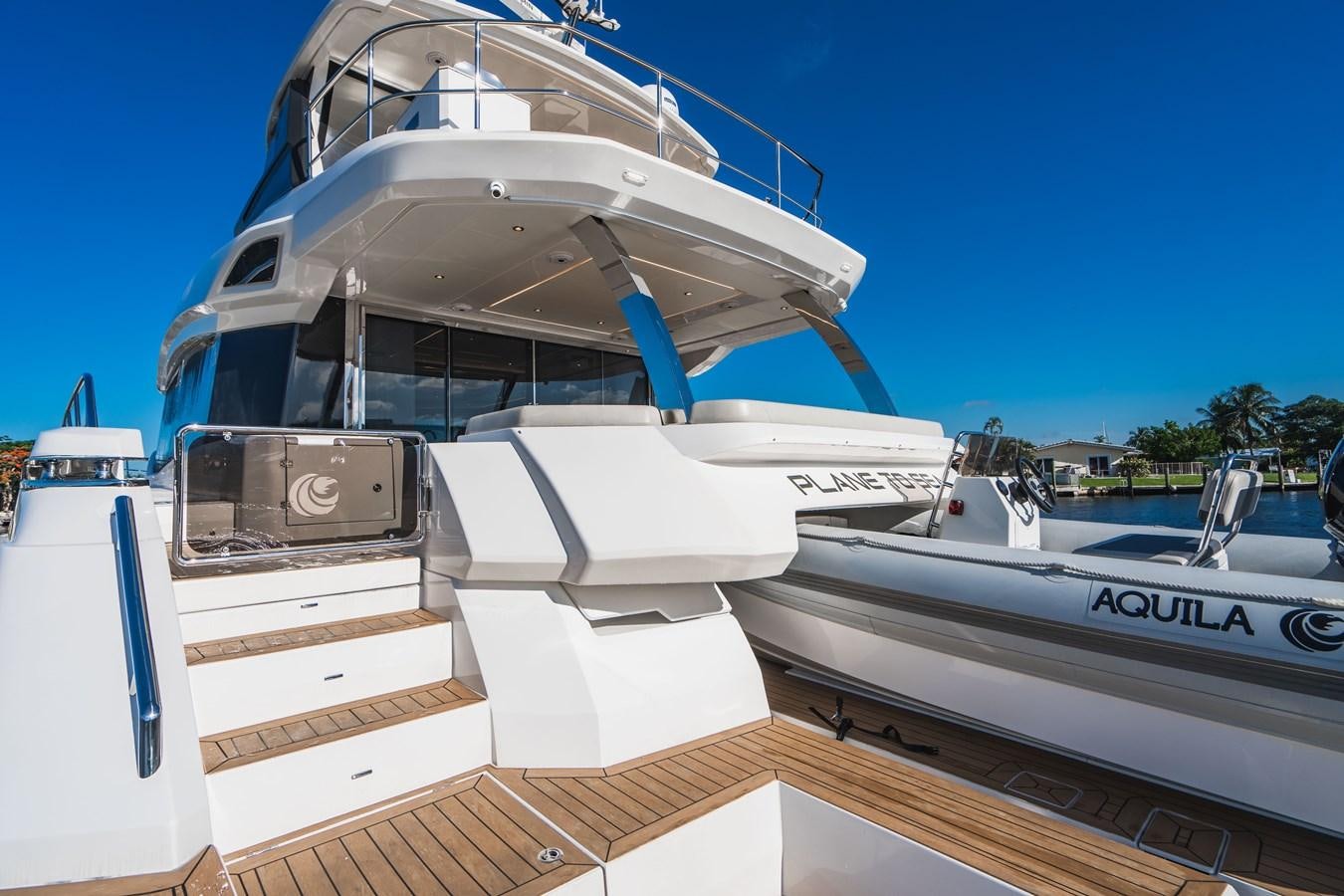 a boat docked at a pier aboard PLANE TO SEA Yacht for Sale