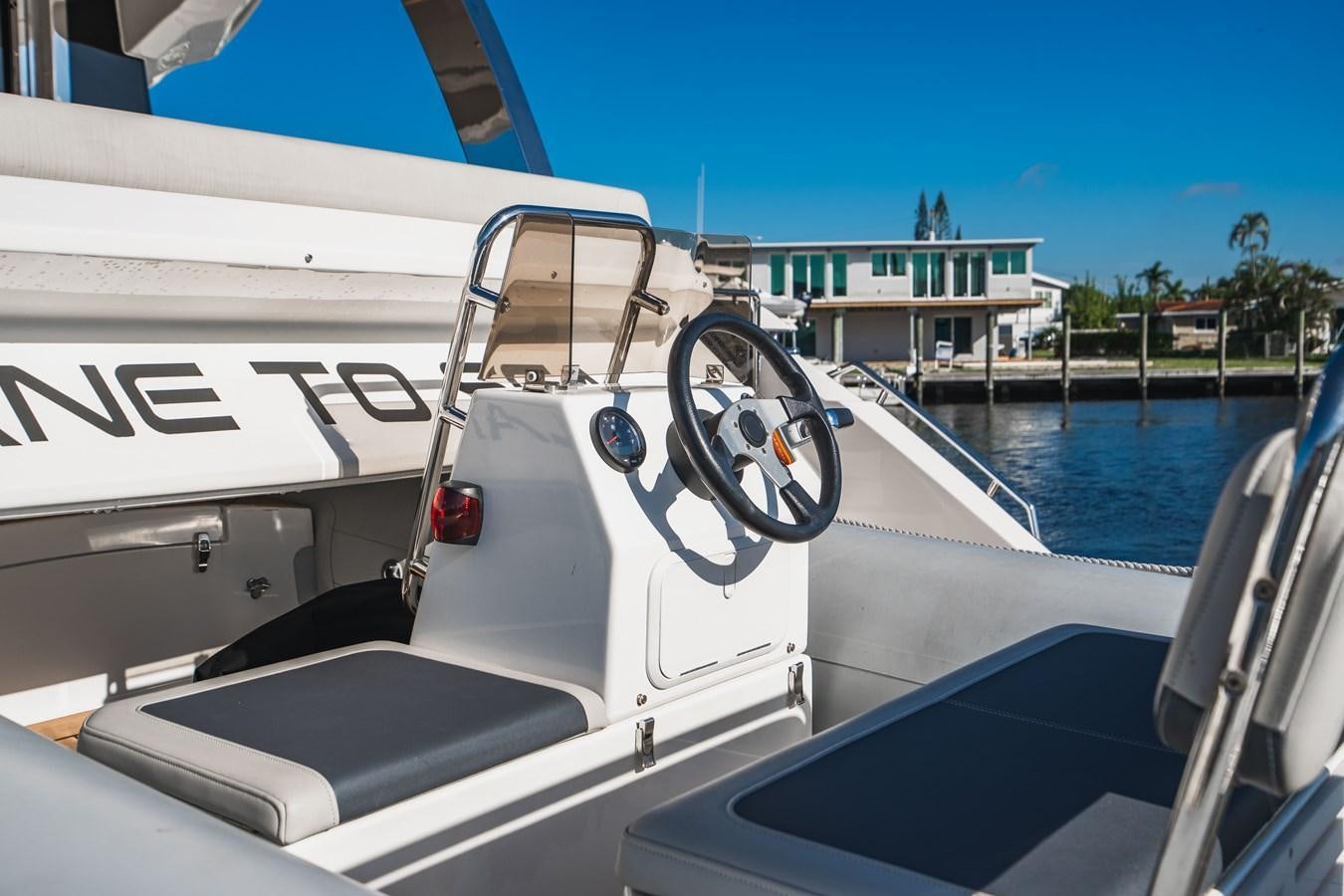 a boat with a steering wheel aboard PLANE TO SEA Yacht for Sale