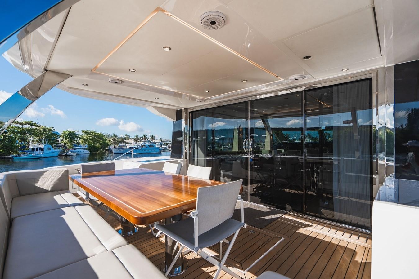 a room with a table and chairs aboard PLANE TO SEA Yacht for Sale