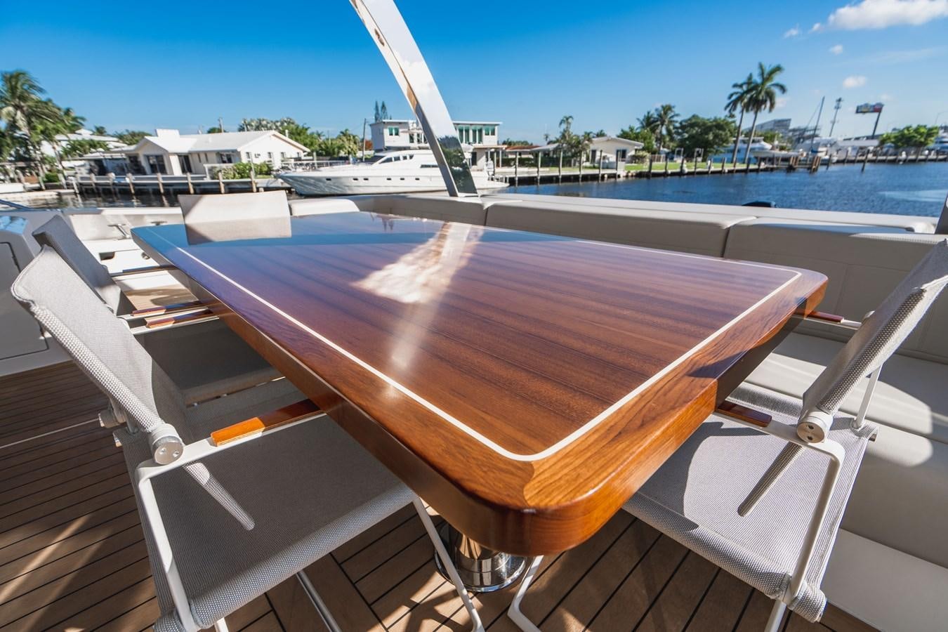 a table with chairs on it aboard PLANE TO SEA Yacht for Sale