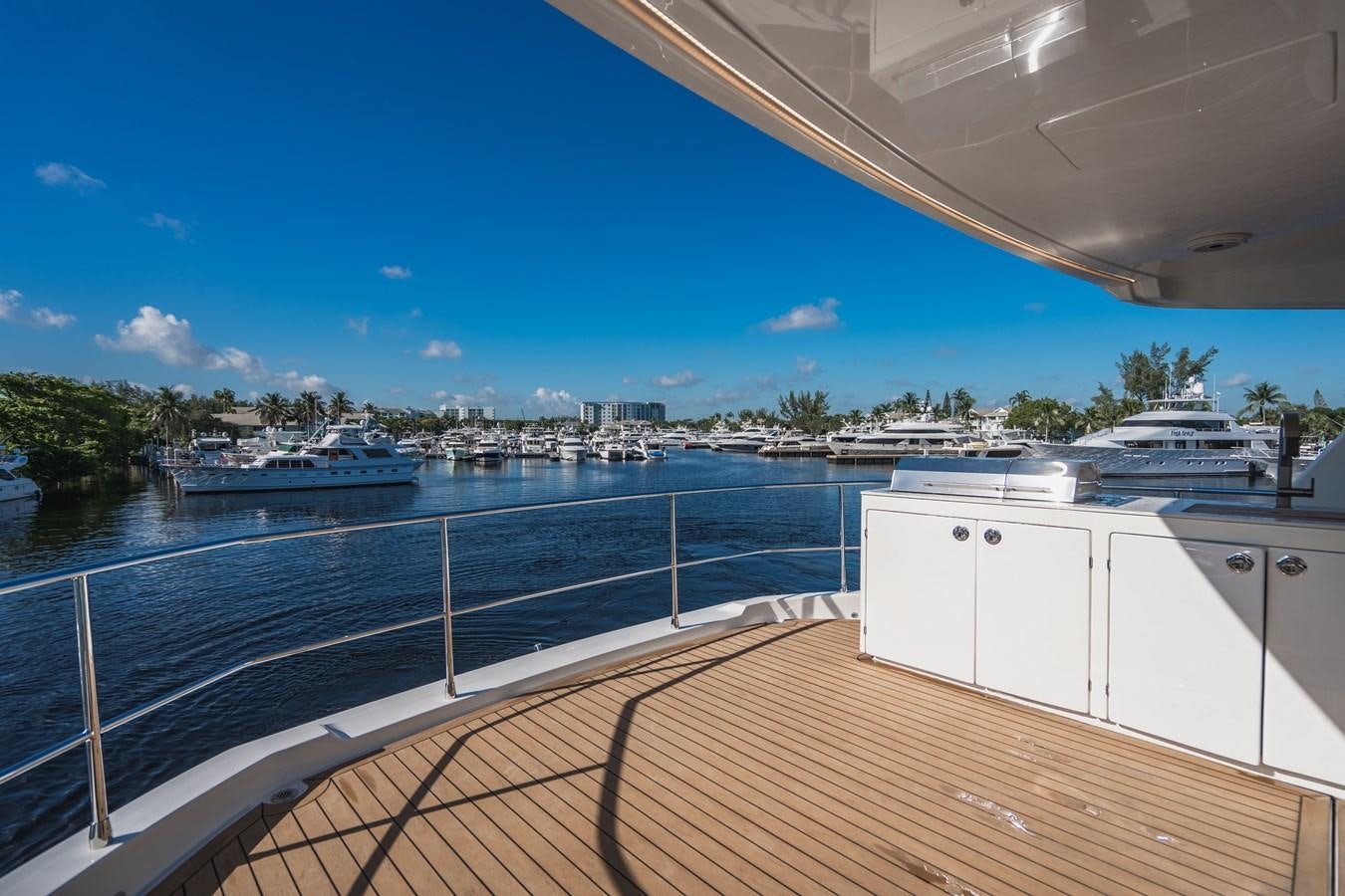 a deck with a view of a city and water aboard PLANE TO SEA Yacht for Sale