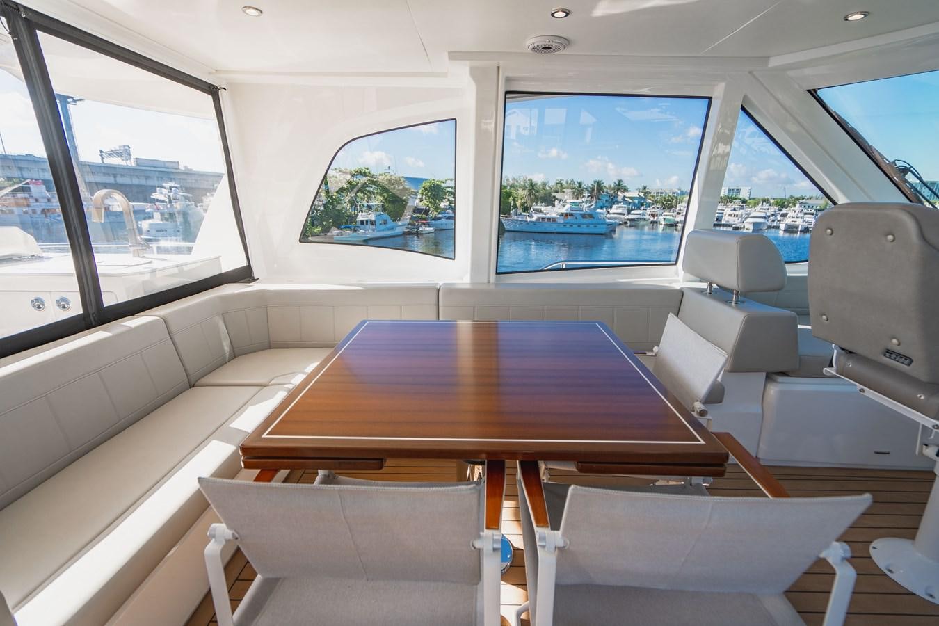 a table with chairs around it aboard PLANE TO SEA Yacht for Sale