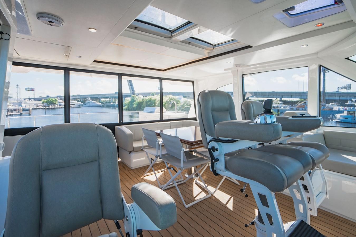 inside of a vehicle with a large window and a view of the city aboard PLANE TO SEA Yacht for Sale