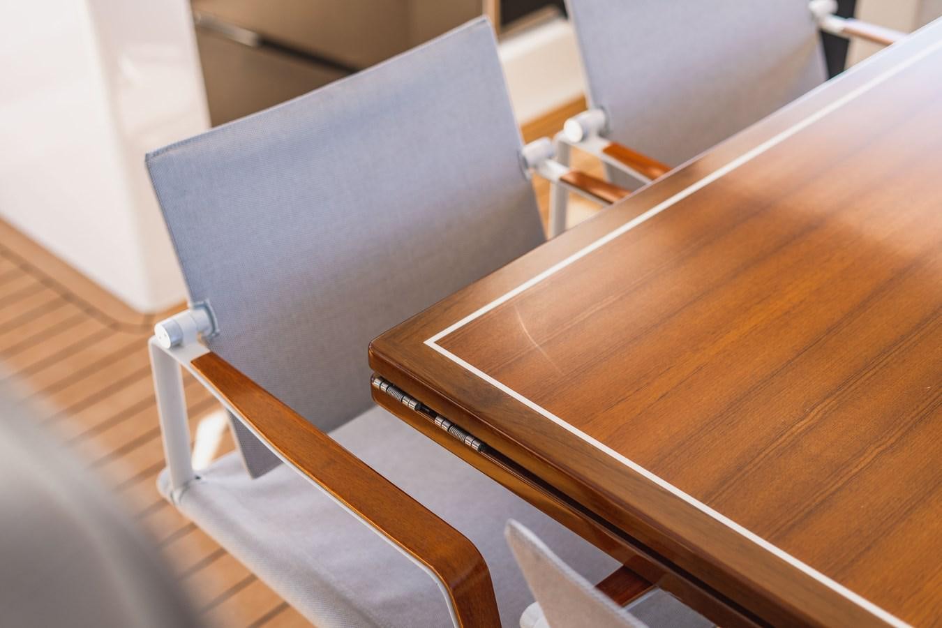 a wooden chair with a cushion aboard PLANE TO SEA Yacht for Sale