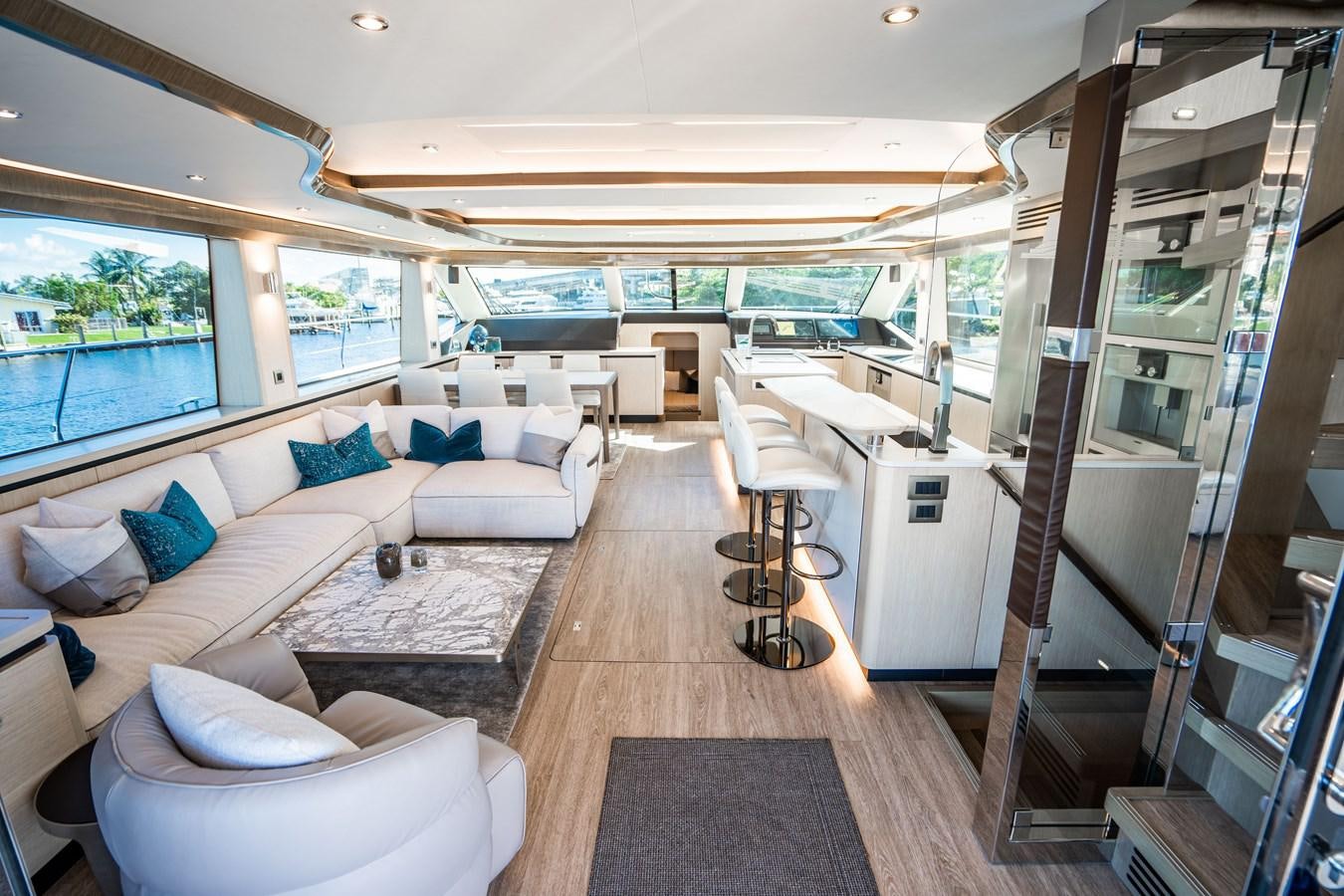 a living room with a large window aboard PLANE TO SEA Yacht for Sale