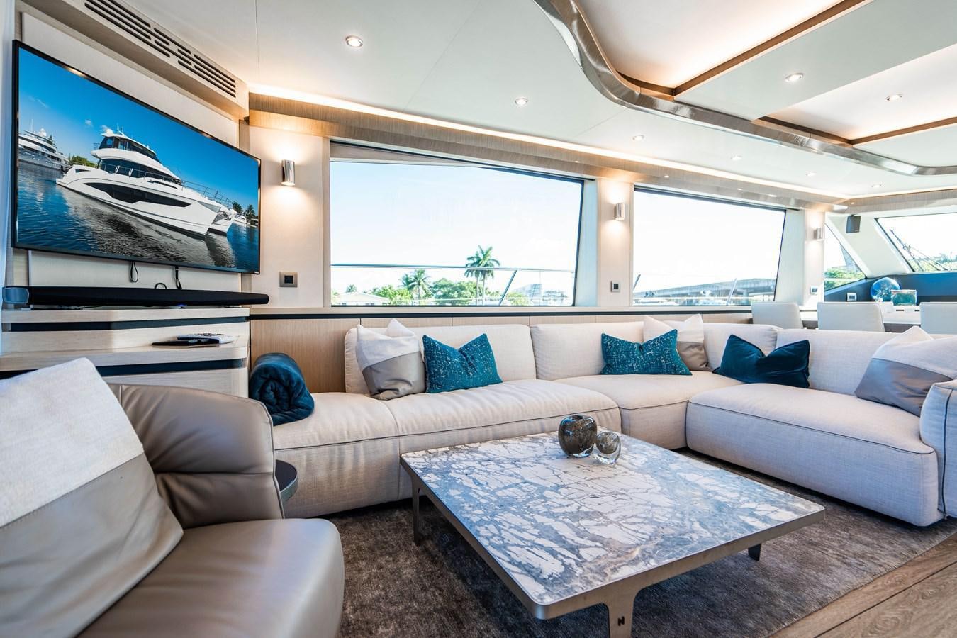 a living room with a large screen aboard PLANE TO SEA Yacht for Sale