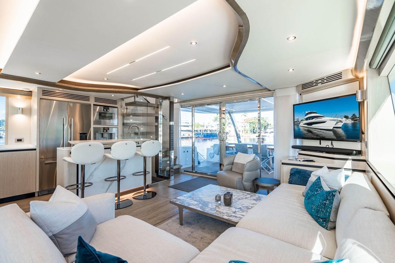 a living room with a large window aboard PLANE TO SEA Yacht for Sale