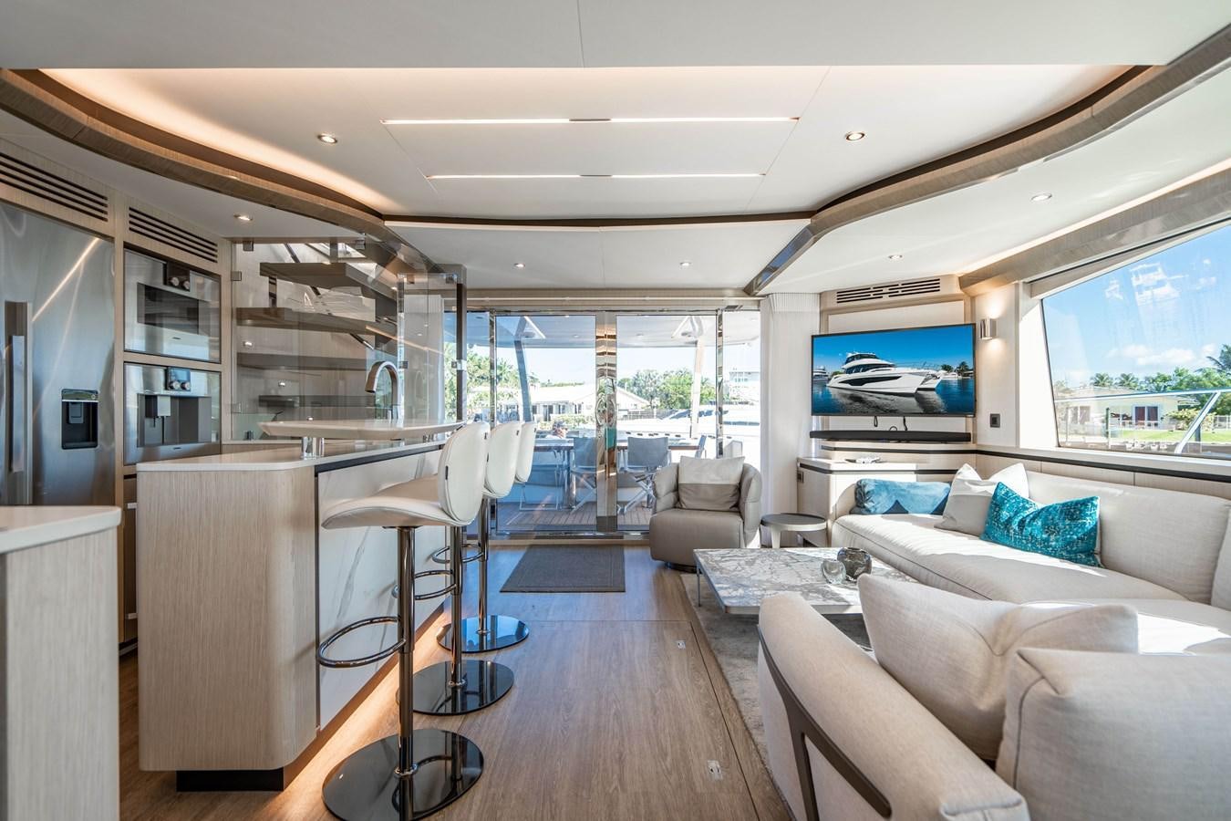 a room with a large window and a table with chairs and a large window aboard PLANE TO SEA Yacht for Sale