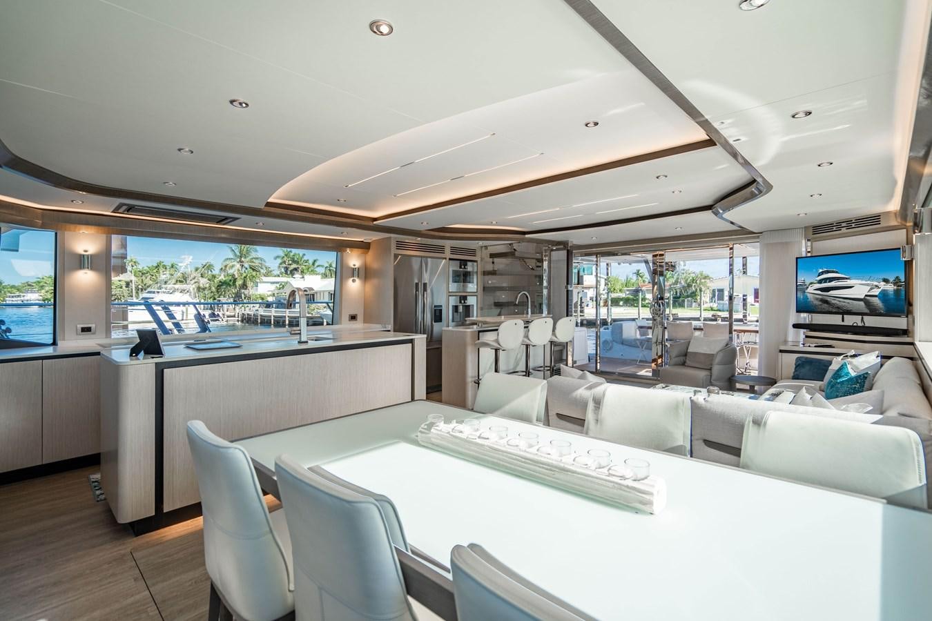 a room with a table and chairs aboard PLANE TO SEA Yacht for Sale