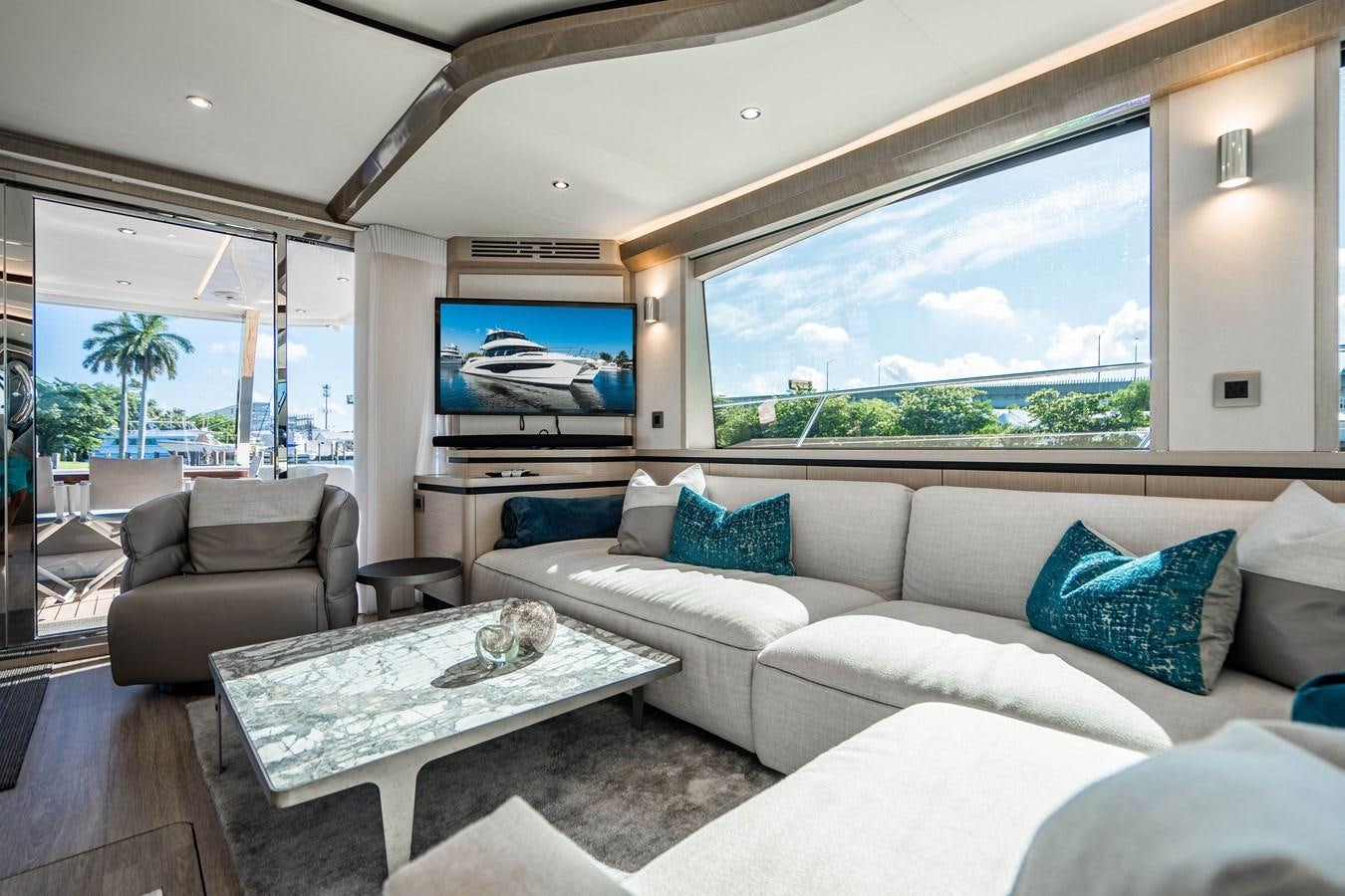 a living room with a large window aboard PLANE TO SEA Yacht for Sale