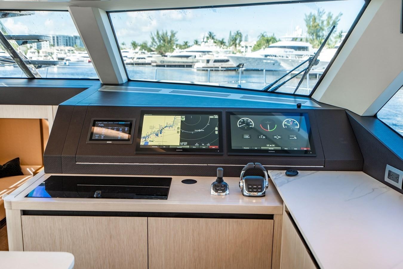 a desk with a computer and a window aboard PLANE TO SEA Yacht for Sale
