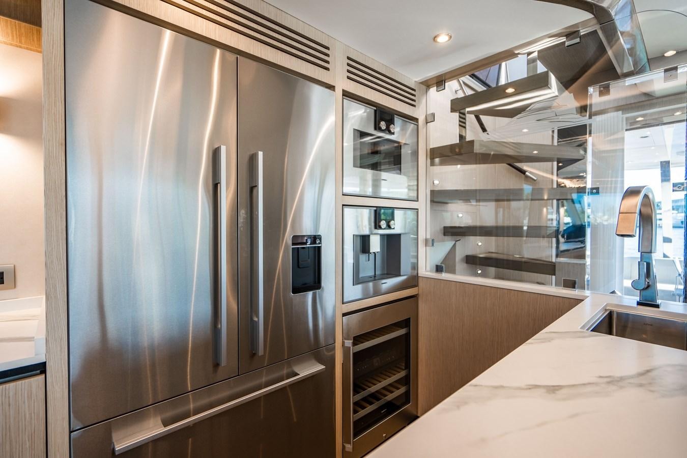 a kitchen with a stainless steel refrigerator aboard PLANE TO SEA Yacht for Sale