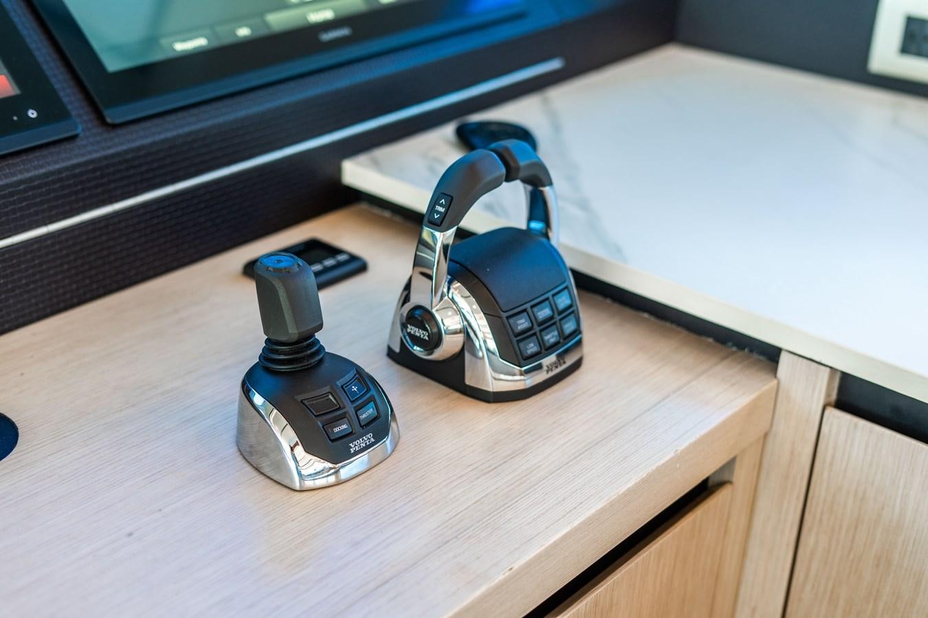 a pair of headphones on a table aboard PLANE TO SEA Yacht for Sale