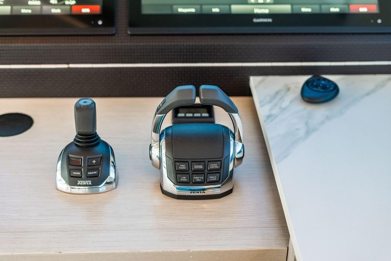 a couple of electronic devices on a table aboard PLANE TO SEA Yacht for Sale