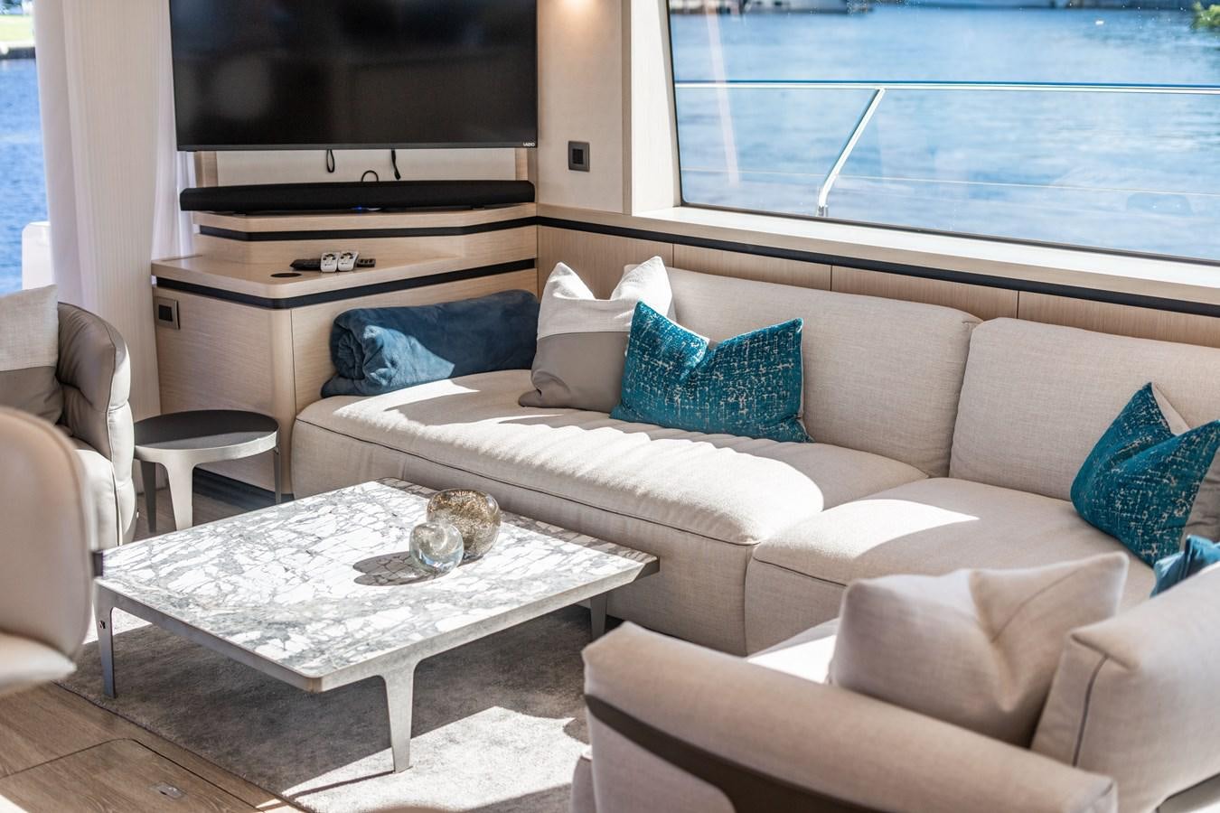 a living room with a couch and a tv aboard PLANE TO SEA Yacht for Sale