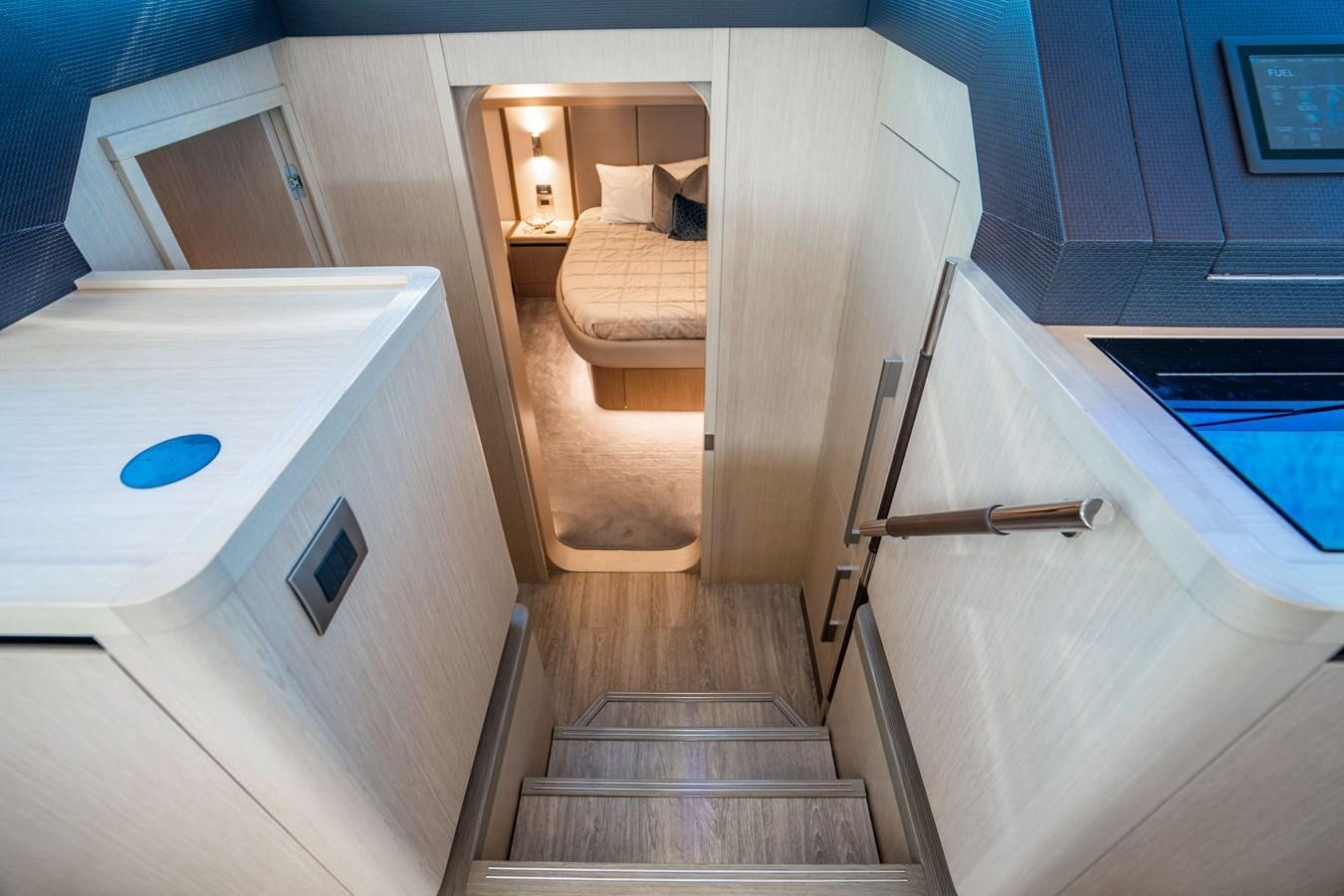 a room with a bed and a staircase aboard PLANE TO SEA Yacht for Sale