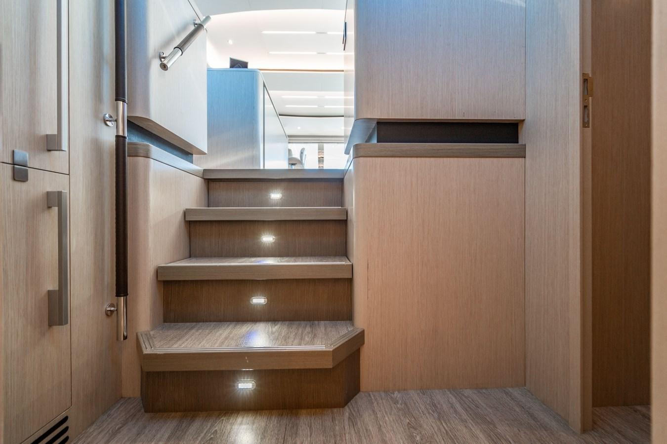 a wooden staircase in a room aboard PLANE TO SEA Yacht for Sale