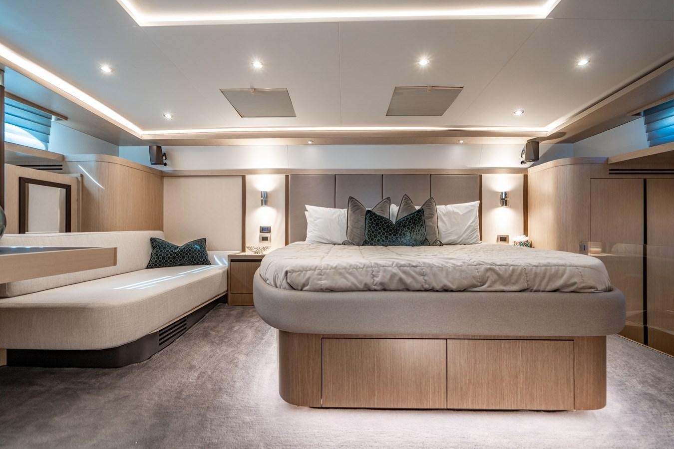 a room with a bed and a couch aboard PLANE TO SEA Yacht for Sale