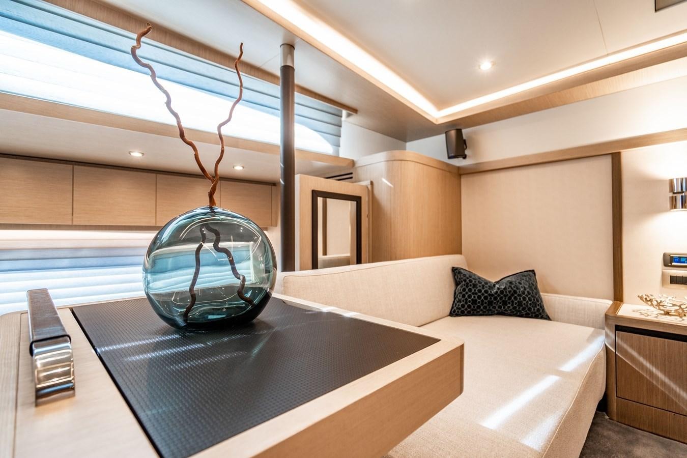 a modern bedroom with a glass chandelier aboard PLANE TO SEA Yacht for Sale