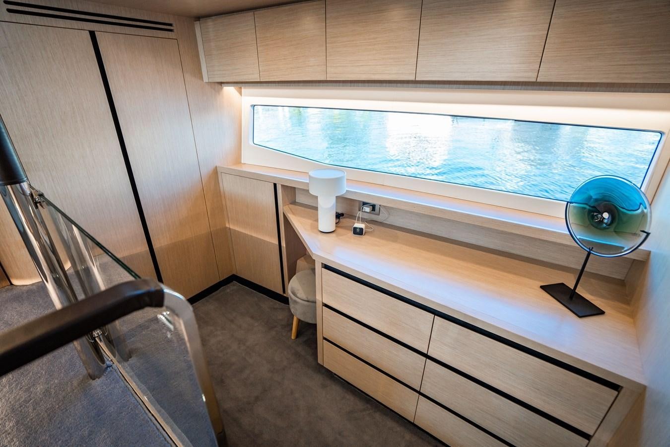 a room with a table and a television aboard PLANE TO SEA Yacht for Sale