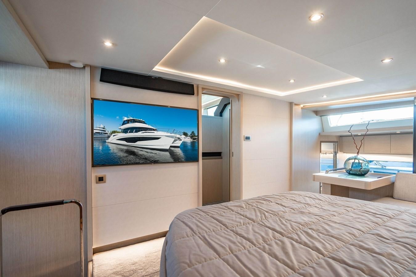 a bedroom with a bed and a television aboard PLANE TO SEA Yacht for Sale