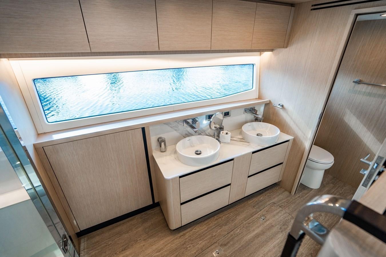 a bathroom with a sink and a toilet aboard PLANE TO SEA Yacht for Sale