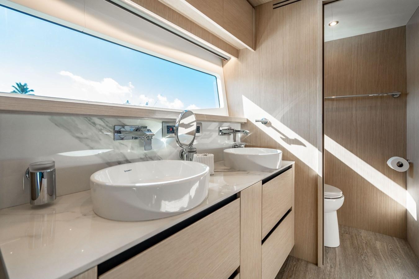 a bathroom with a sink and a mirror aboard PLANE TO SEA Yacht for Sale