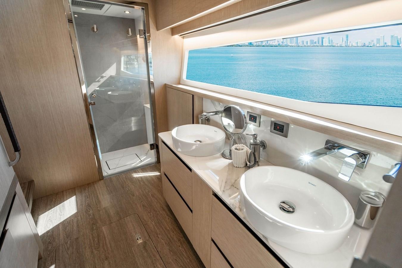 a bathroom with a sink and a large window aboard PLANE TO SEA Yacht for Sale