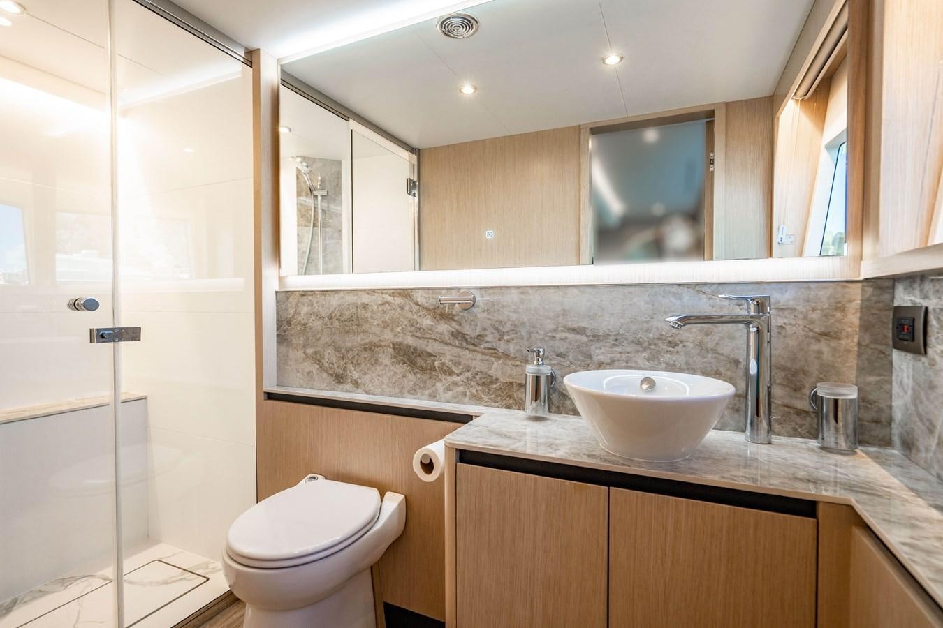 a bathroom with a sink and toilet aboard PLANE TO SEA Yacht for Sale