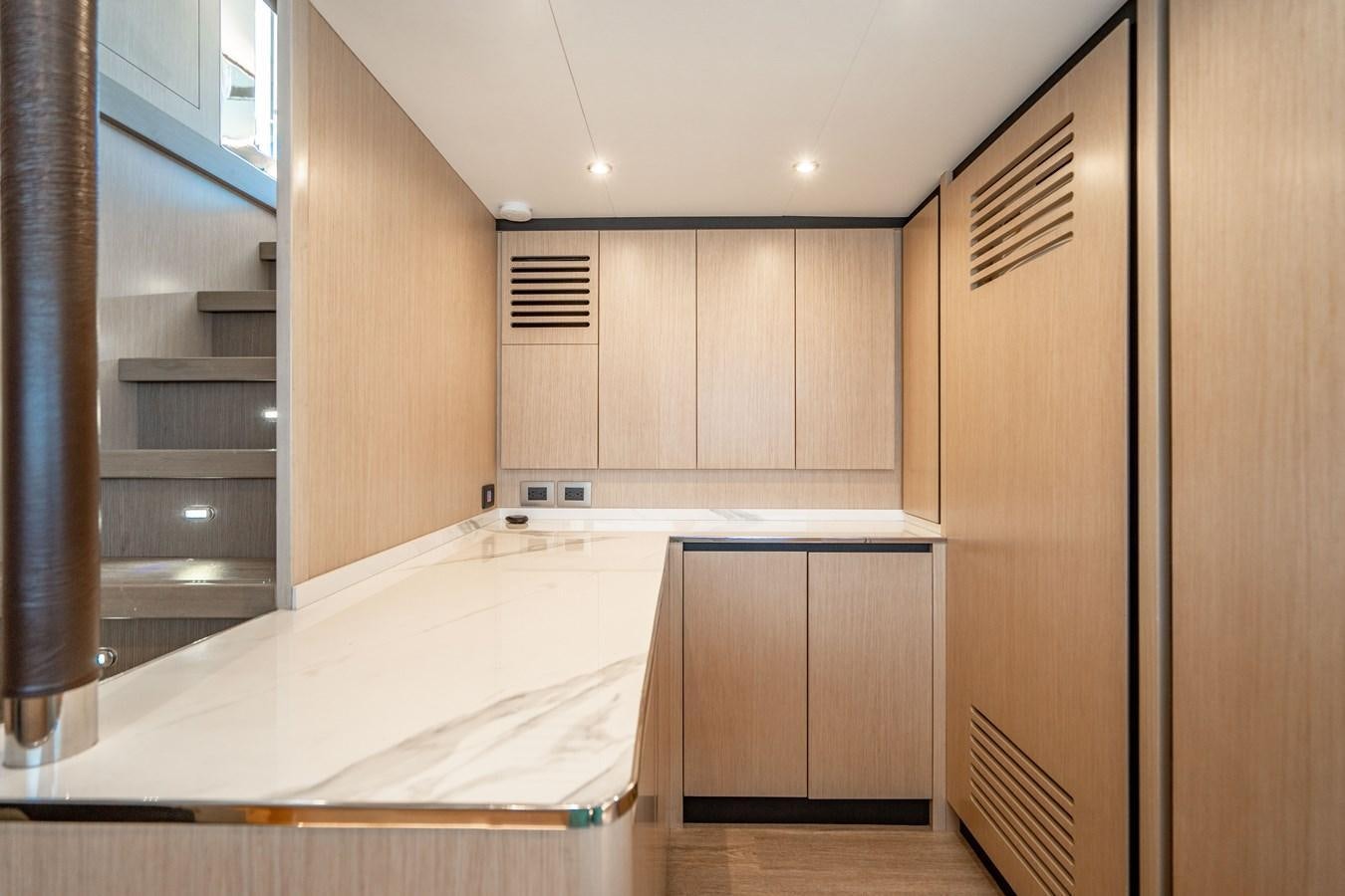 a large empty room with a bed aboard PLANE TO SEA Yacht for Sale