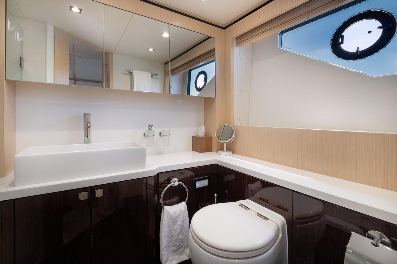 a bathroom with a sink toilet and a mirror aboard SUNSEEKER PREDATOR 68 Yacht for Sale