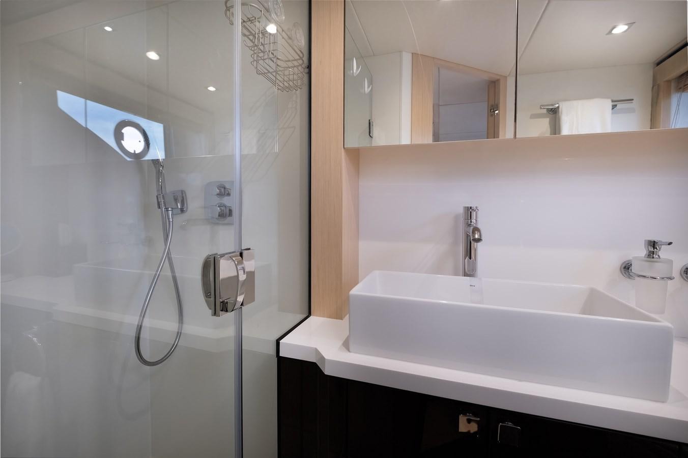 a bathroom with a glass shower aboard SUNSEEKER PREDATOR 68 Yacht for Sale