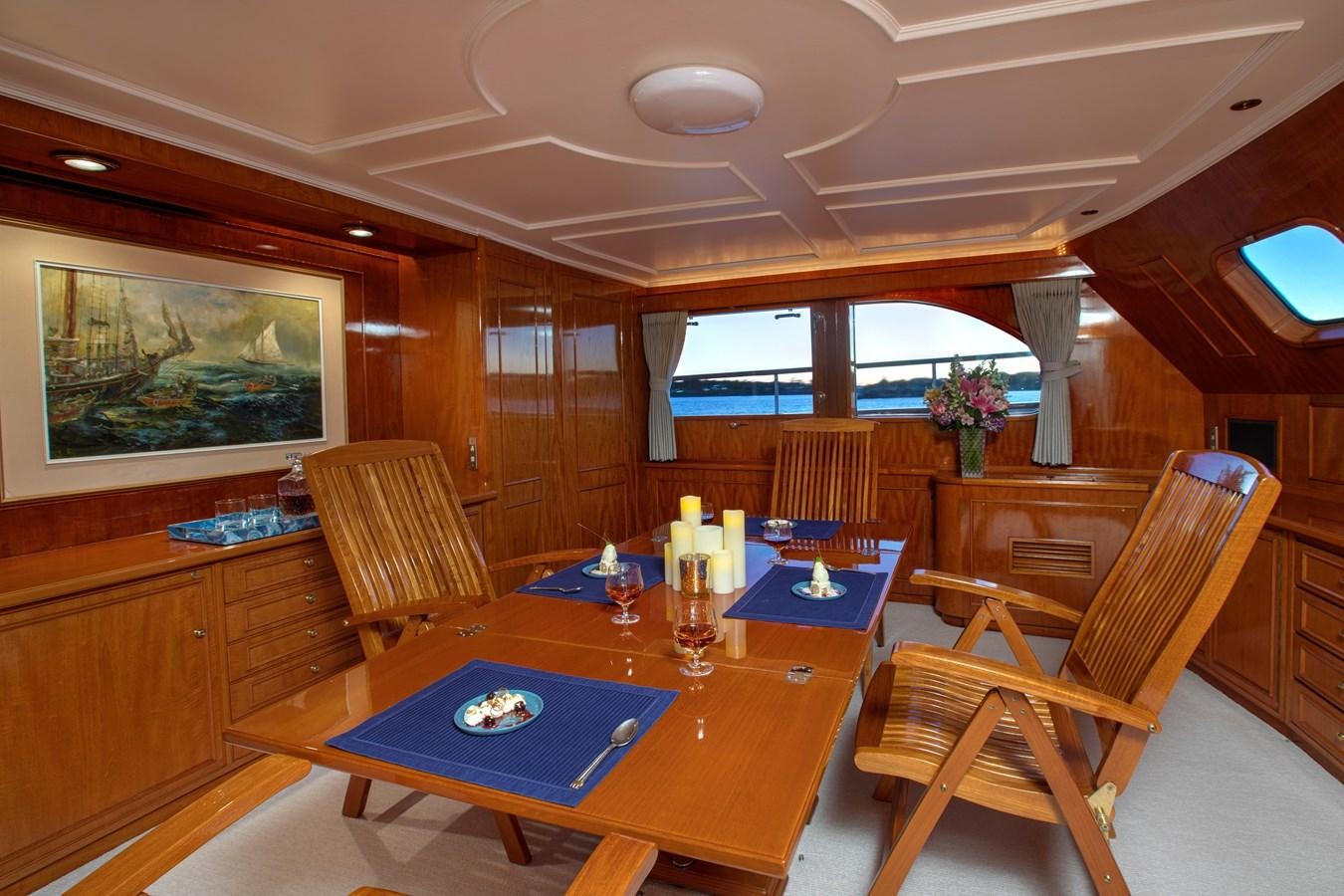 a dining room with a table and chairs aboard MARYBELLE Yacht for Sale