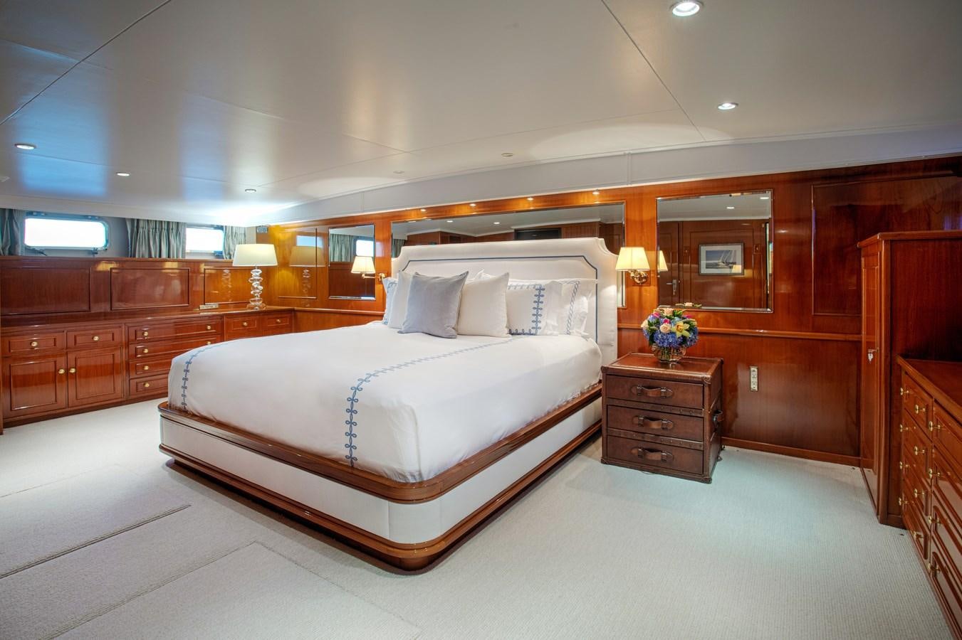a bedroom with a bed and a dresser aboard MARYBELLE Yacht for Sale