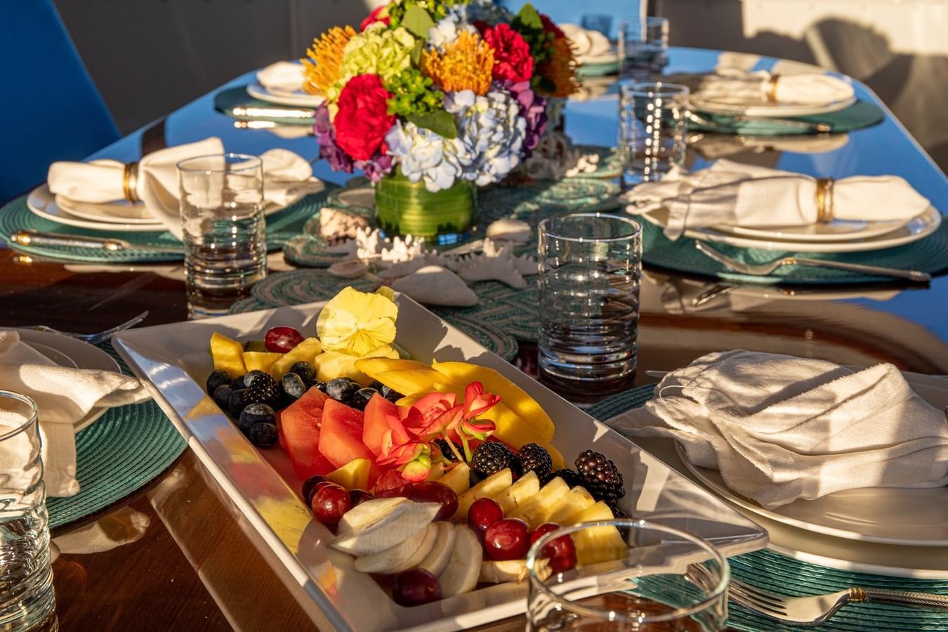 a table with plates and glasses aboard MARYBELLE Yacht for Sale