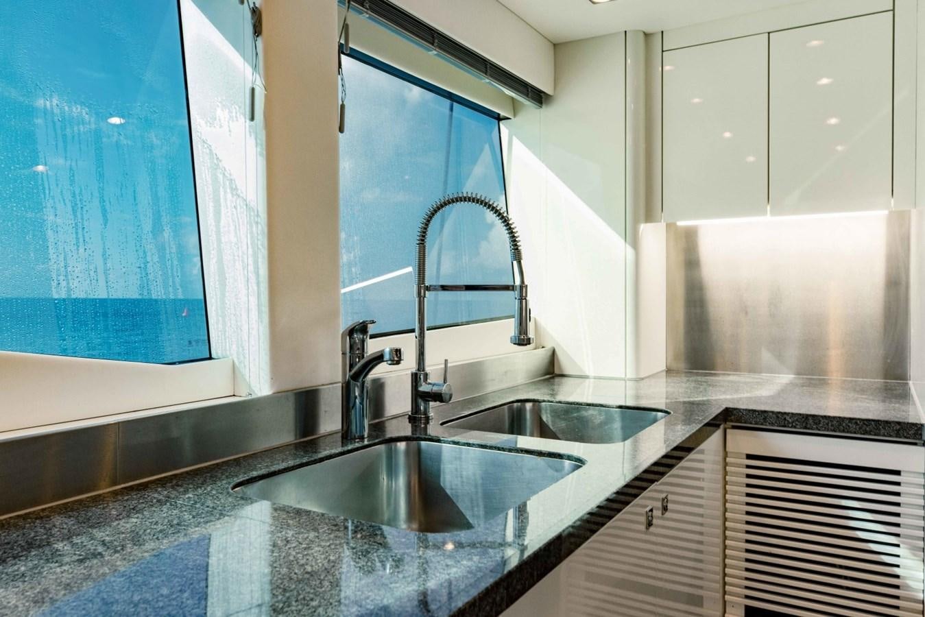 a kitchen with a sink and a large mirror aboard TAYRONA Yacht for Sale