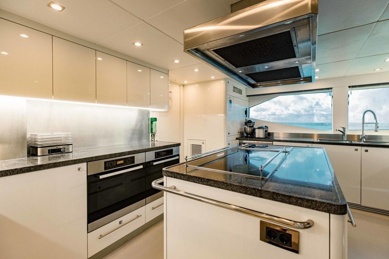 a kitchen with white cabinets aboard TAYRONA Yacht for Sale