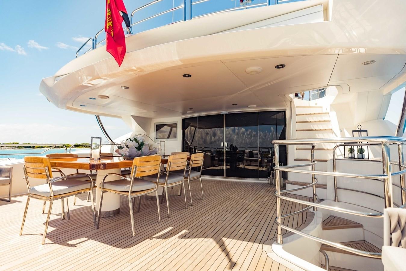 a room with a table chairs and a railing aboard TAYRONA Yacht for Sale