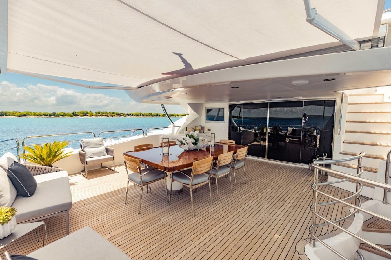 a room with a table chairs and a pool aboard TAYRONA Yacht for Sale