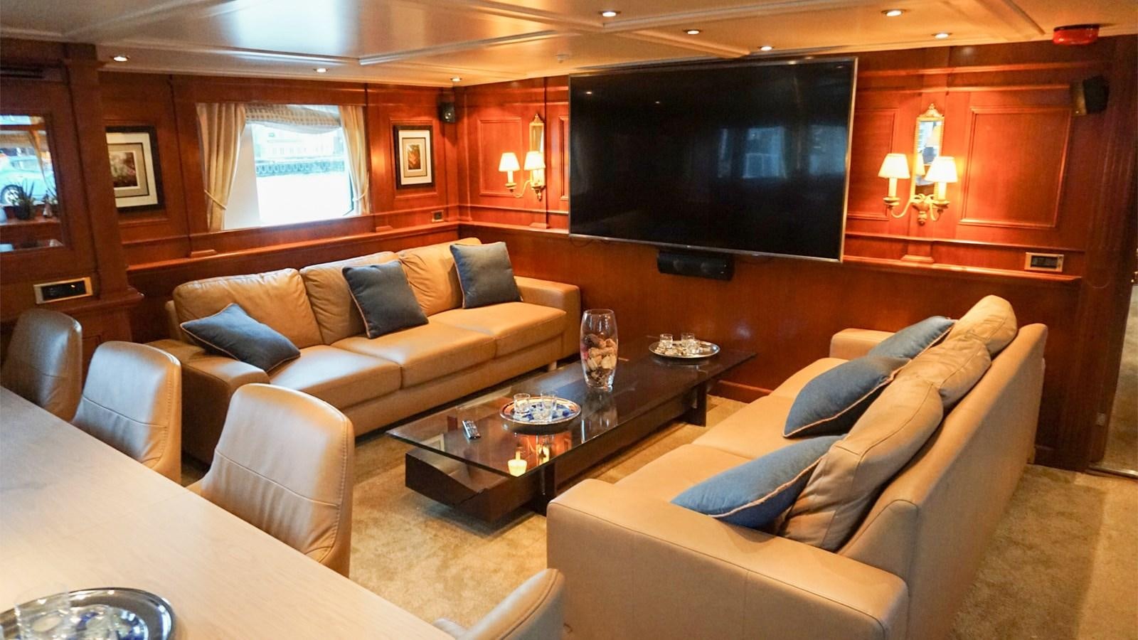 a living room with a couch and a tv aboard CHANTAL Yacht for Sale
