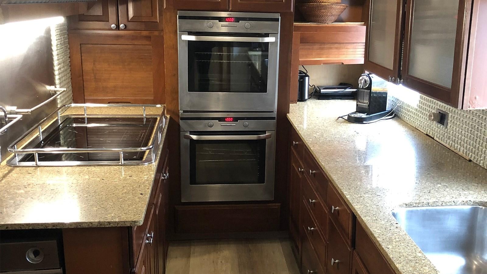 a kitchen with a stainless steel oven aboard CHANTAL Yacht for Sale