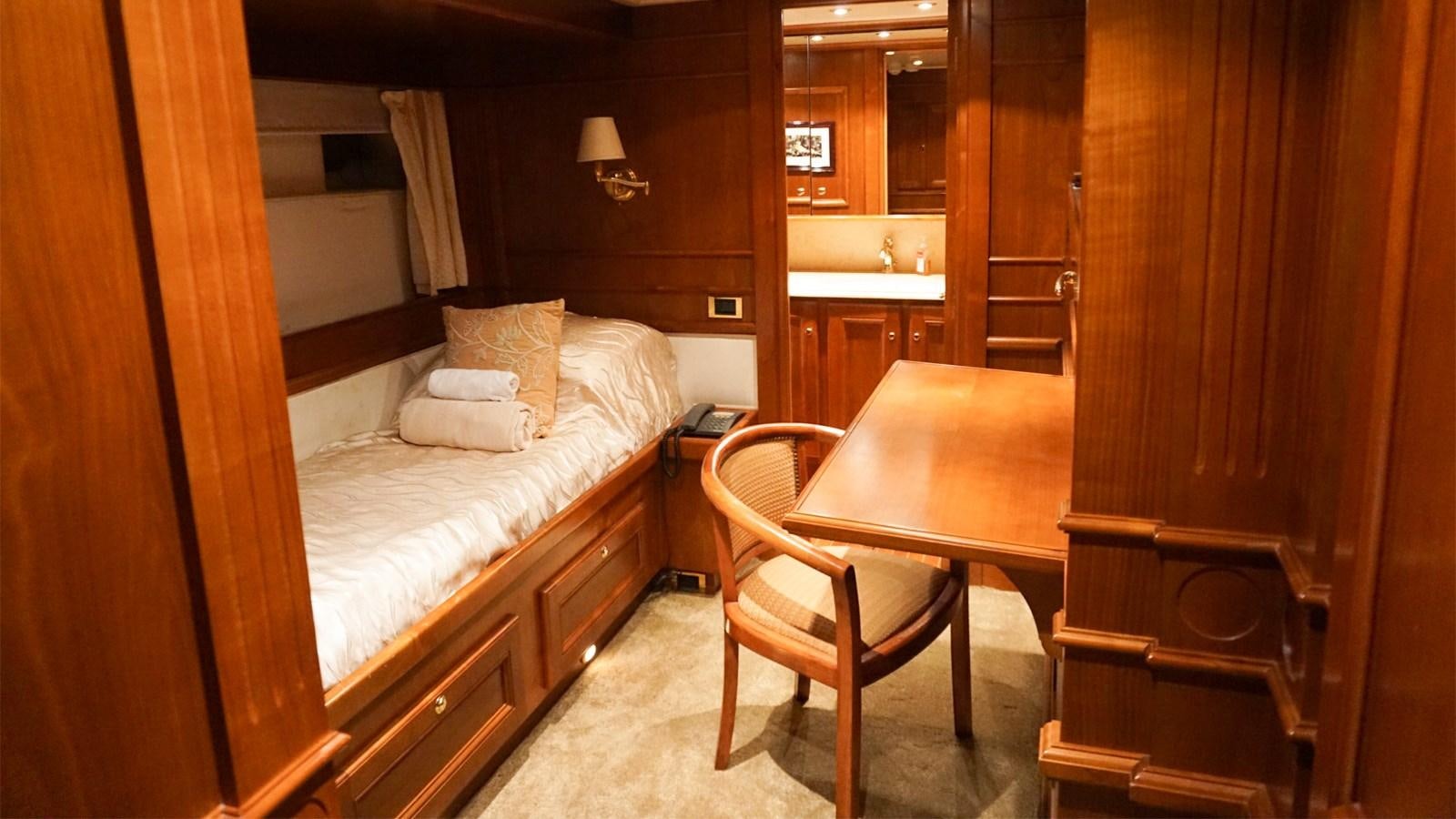 a bed and a desk in a room aboard CHANTAL Yacht for Sale