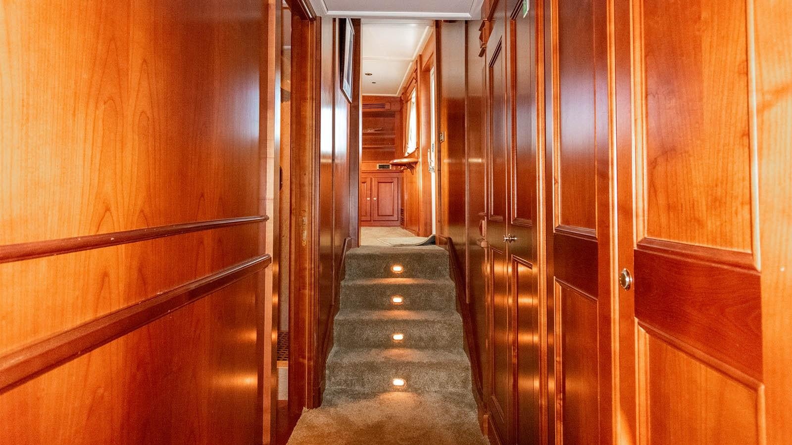 a wooden staircase in a building aboard CHANTAL Yacht for Sale