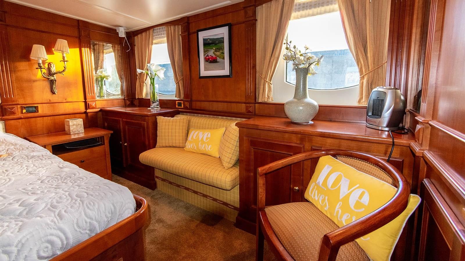 a room with a bed and a desk aboard CHANTAL Yacht for Sale