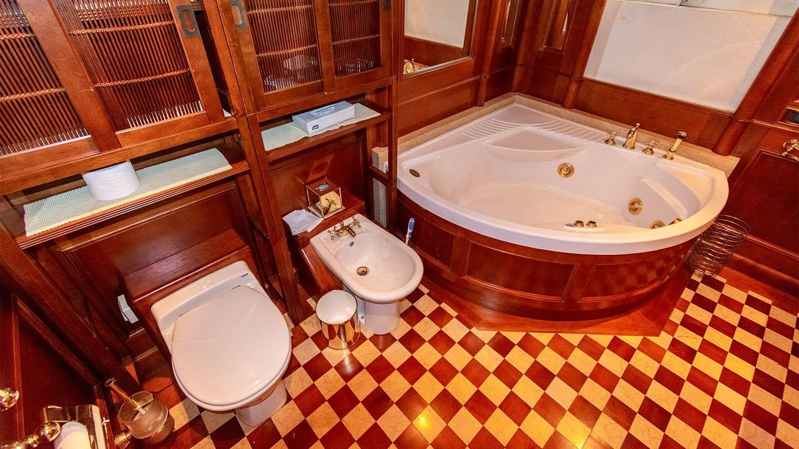 a bathroom with a tub sink and toilet aboard CHANTAL Yacht for Sale