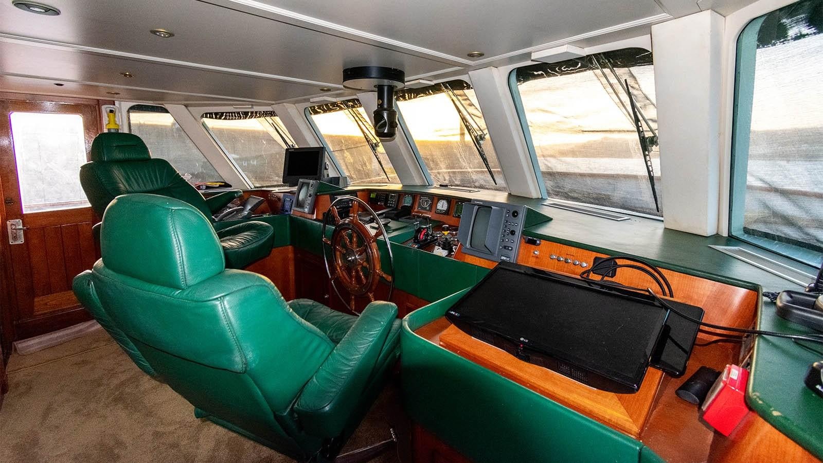 inside of a vehicle with a black laptop on the table aboard CHANTAL Yacht for Sale